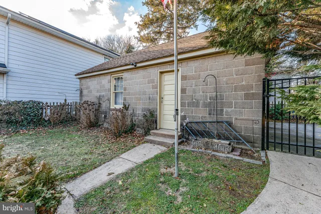 a backyard of a house with plants and outdoor seating
