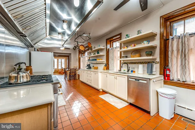 a kitchen with stainless steel appliances granite countertop a sink and cabinets