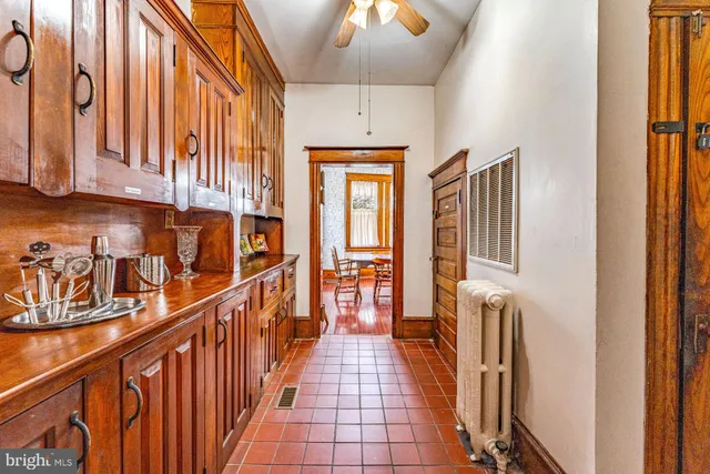 a view of a hallway with wooden floors and stairs