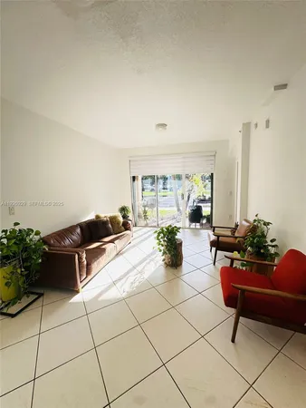 a living room with furniture and flowers