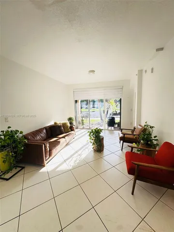 a living room with furniture and flowers
