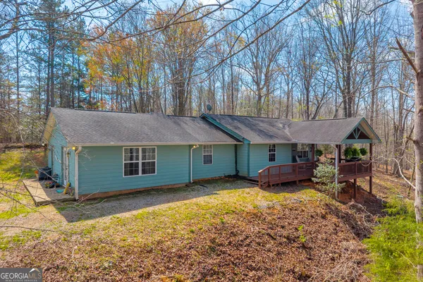 a backyard of a house with yard and outdoor seating