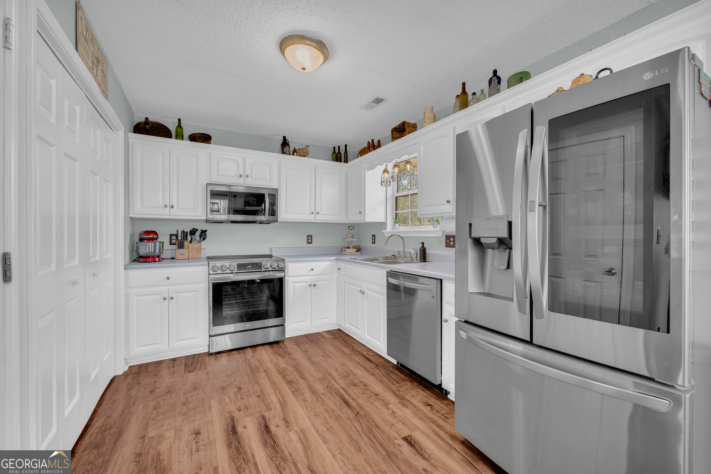 234 Old River Road Cornelia, GA 30531 - Photo 14 of 40 a kitchen with white cabinets and white appliances