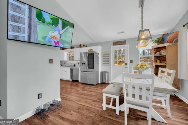a living room with furniture flowerpot and wooden floor
