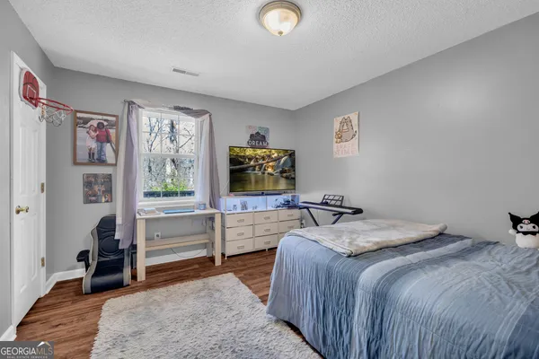 a bedroom with furniture and a window