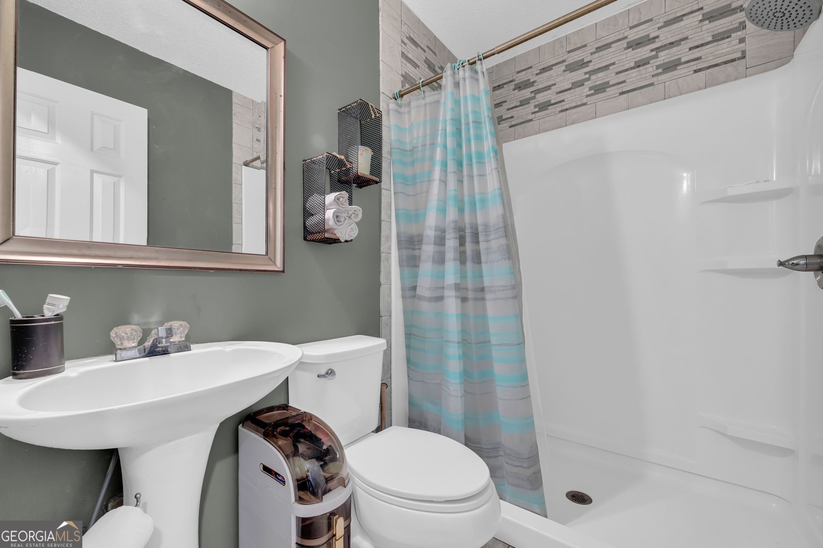 234 Old River Road Cornelia, GA 30531 - Photo 26 of 40 a bathroom with a sink a toilet and shower