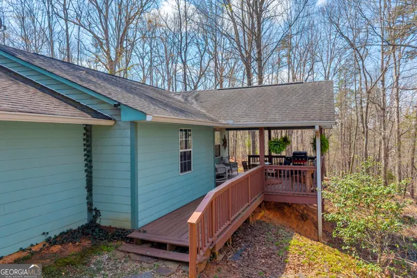 a view of house with backyard and seating area
