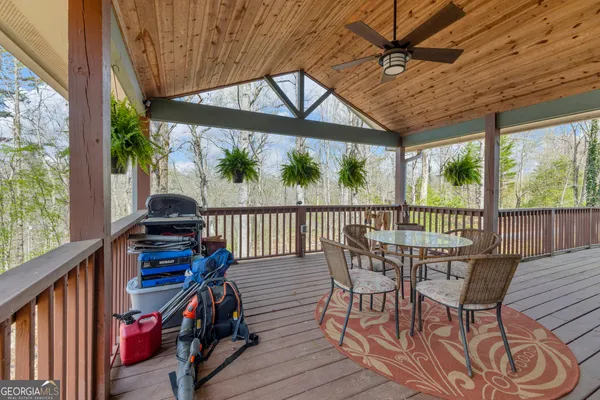 a view of a chairs and table in the balcony