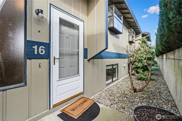 an entryway with a flower pot and a fireplace