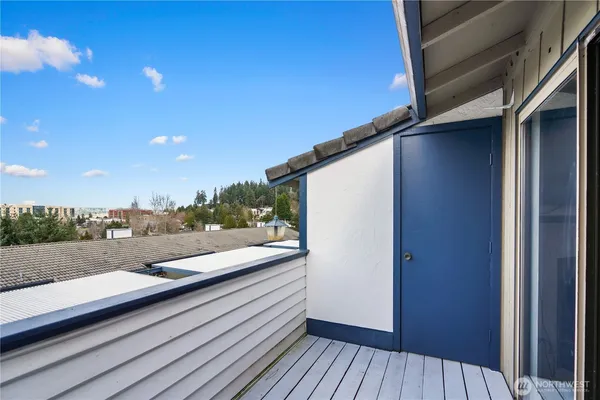 a view of balcony with wooden floor and city view