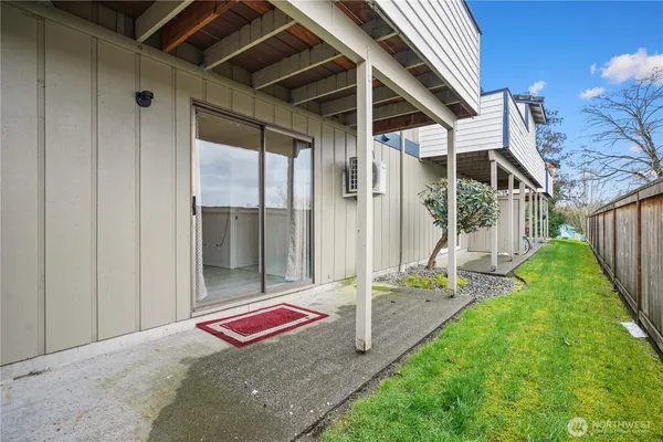 a backyard of a house with table and chairs