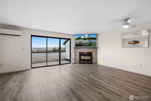 an empty room with wooden floor and fireplace
