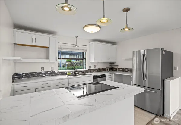 a kitchen with cabinets and stainless steel appliances