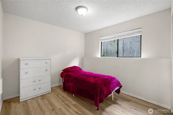 a bedroom with a bed and a window