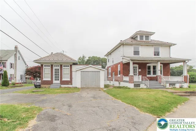 a front view of a house with a yard table and chairs