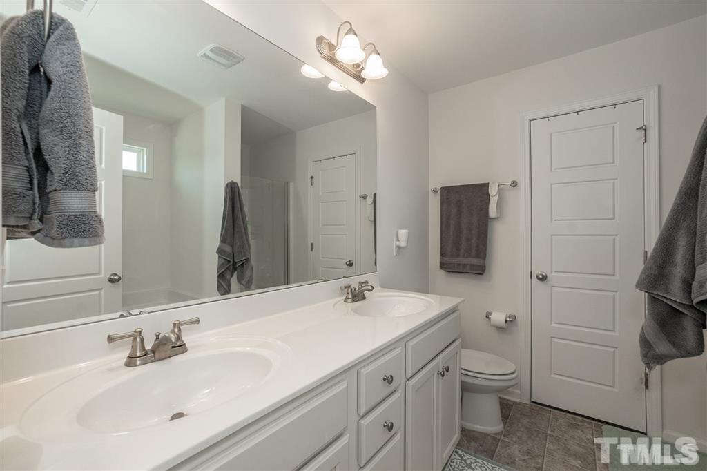 42 Griffith Place Clayton, NC 27520 - Photo 19 of 26 a bathroom with a toilet sink and mirror
