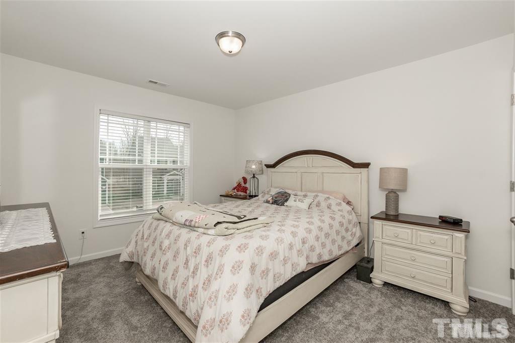 42 Griffith Place Clayton, NC 27520 - Photo 21 of 26 a bedroom with a bed and a window