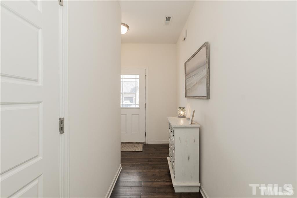 42 Griffith Place Clayton, NC 27520 - Photo 3 of 26 a view of a hallway with wooden floor and a bathroom