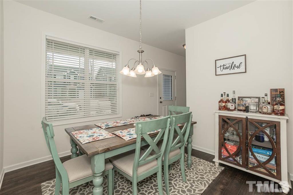 42 Griffith Place Clayton, NC 27520 - Photo 4 of 26 a view of a dining room with furniture a rug and wooden floor