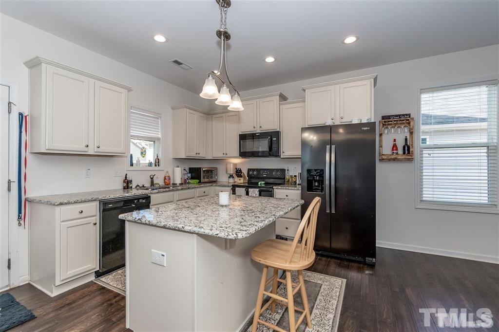 42 Griffith Place Clayton, NC 27520 - Photo 6 of 26 a kitchen with stainless steel appliances granite countertop a refrigerator a stove a sink dishwasher and a refrigerator with wooden floor