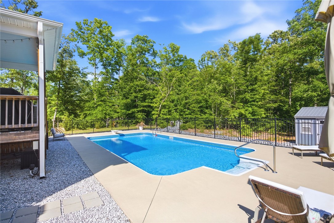 525 16th Circle Walhalla, SC 29691 - Photo 33 of 50 This private outdoor space features a pristine pool, perfect for serene relaxation or lively gatherings.