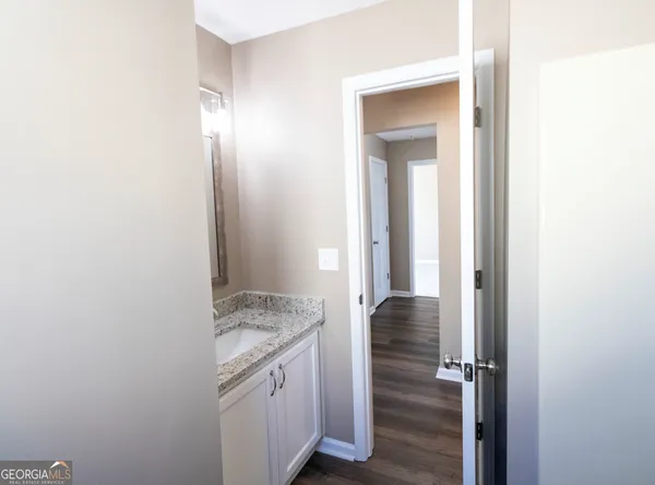a view of walk in closet with wooden floor