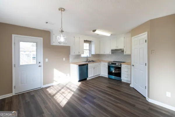 a kitchen with kitchen island granite countertop wooden floors and stainless steel appliances