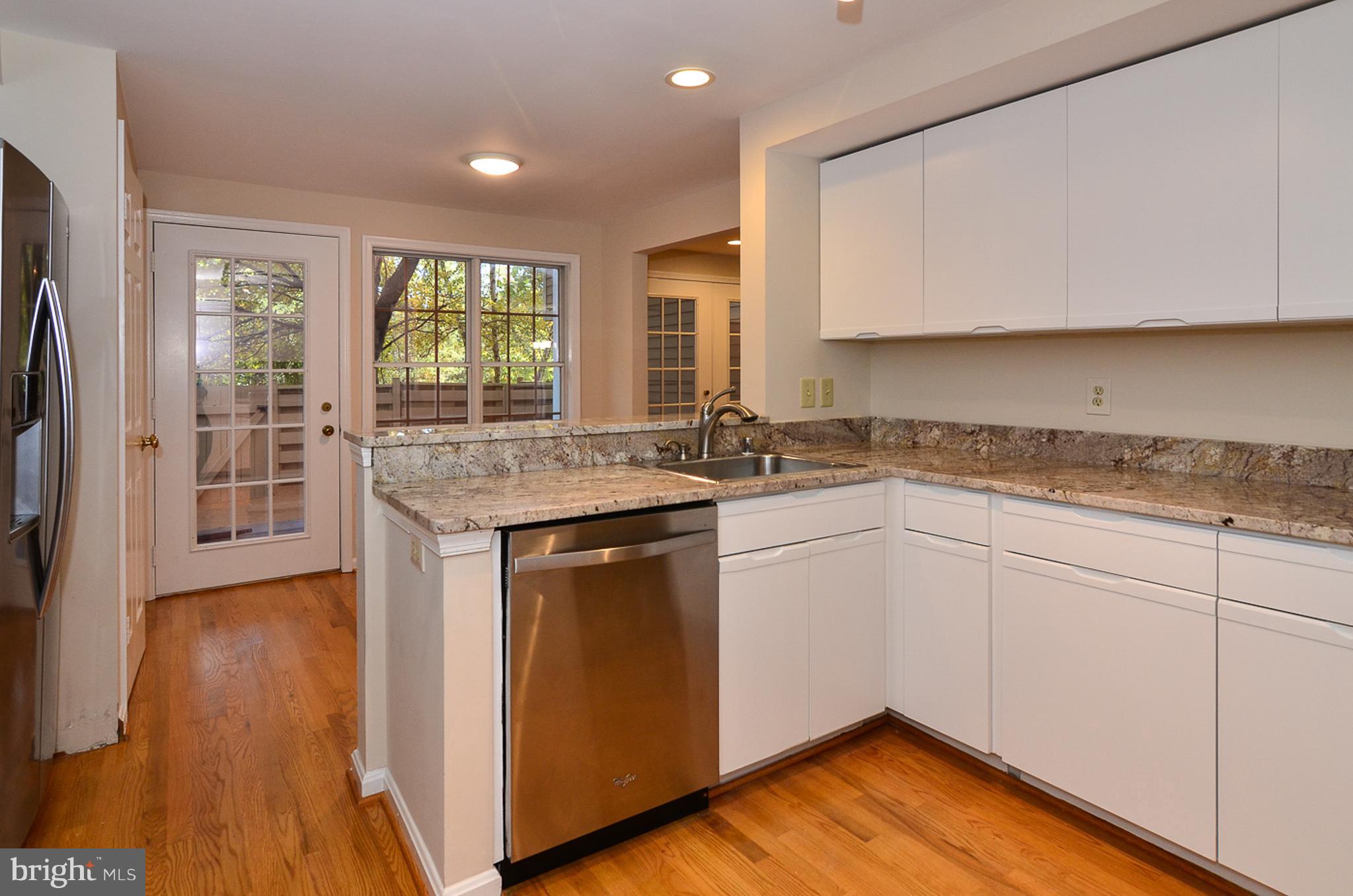 1558 Deer Point Way Reston, VA 20194 - Photo 8 of 22 a kitchen with a sink stove and cabinets