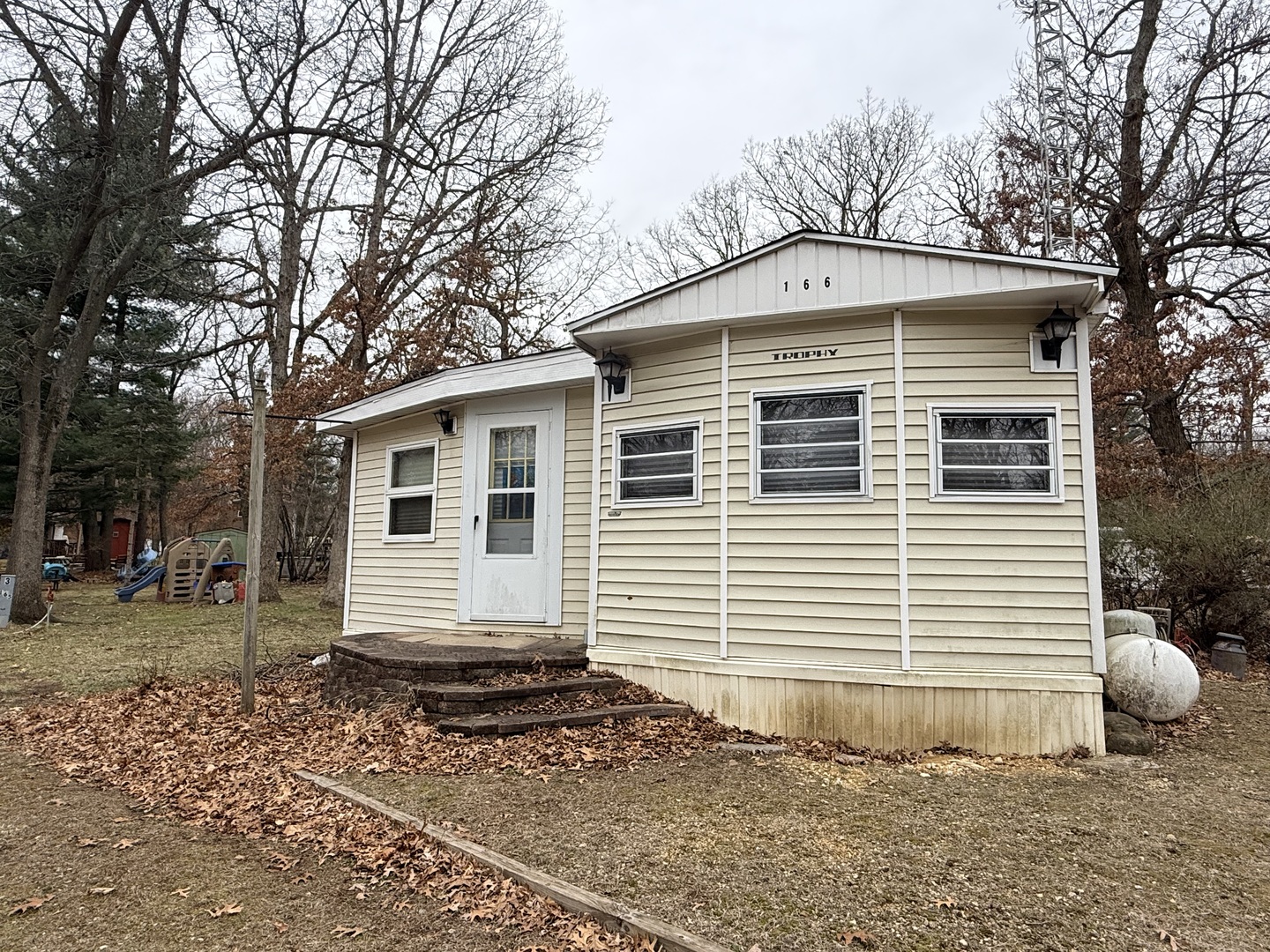 3-166 Woodhaven Lakes Sublette, IL 61367 - Photo 19 of 20 a front view of a house with a yard
