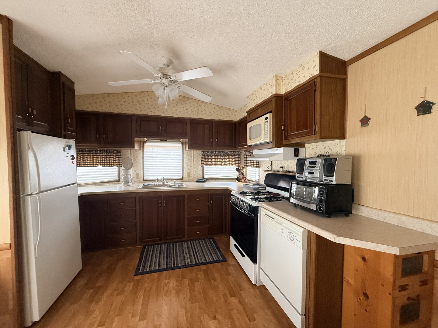 3-166 Woodhaven Lakes Sublette, IL 61367 - Photo 6 of 20 a kitchen with stainless steel appliances a refrigerator a sink a stove a microwave and wooden floors