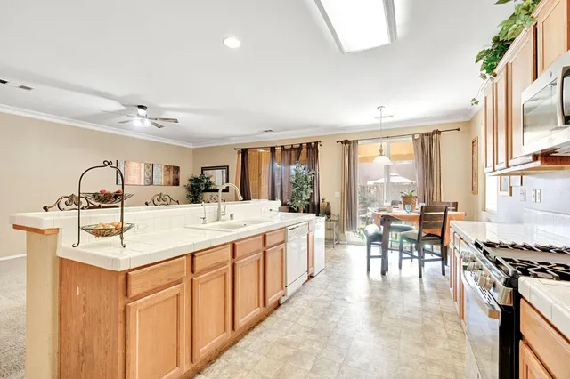 a large white kitchen with a large window