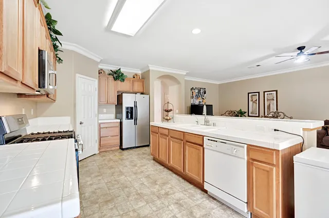 a kitchen that has a lot of cabinets in it and wooden floors