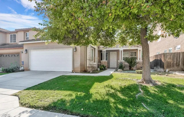 a view of backyard of house with green space