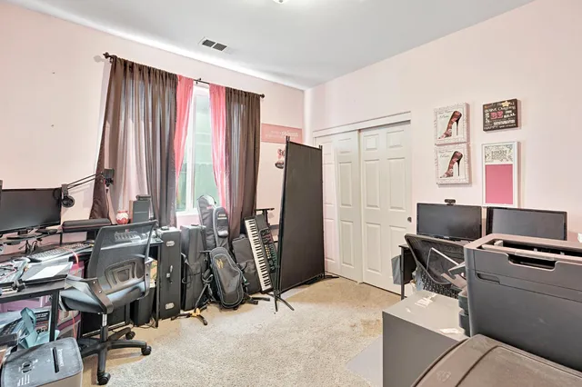 a view of a workspace with furniture and a window