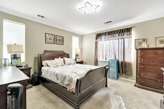 a bedroom with a bed and a dresser