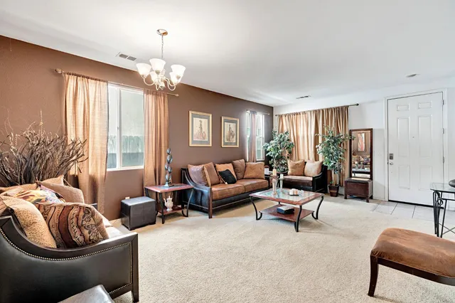 a living room with furniture ceiling fan and a window
