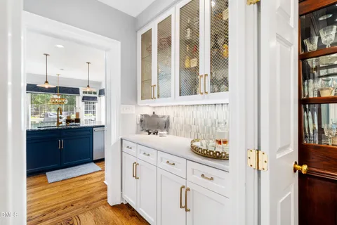 a large kitchen with a table and chairs