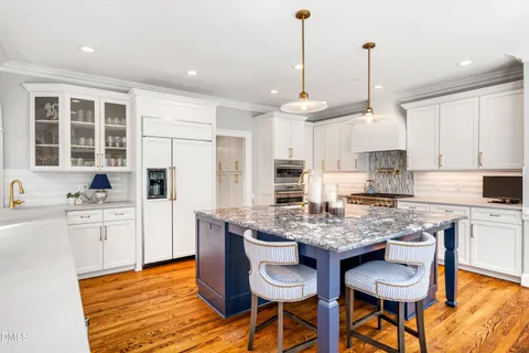 a living room with fireplace furniture and a large window