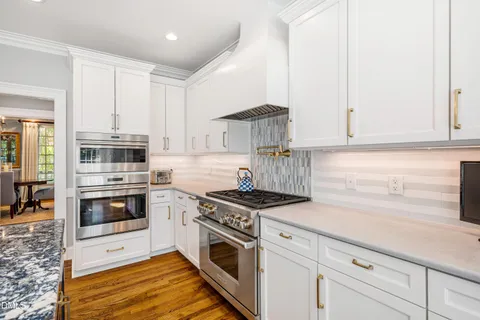 a living room with fireplace furniture and a large window
