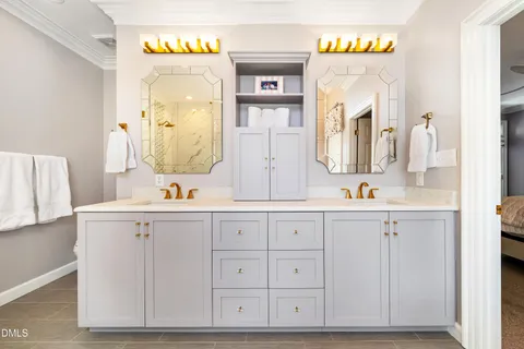 a spacious bedroom with a bed a couch and a large window