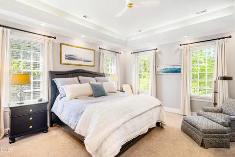 a bed sitting in a room next to a window