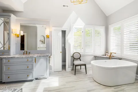 a living room with furniture kitchen view and a chandelier