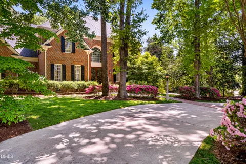 a view of a house with a yard and tree s