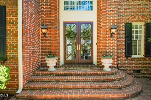 a view of a brick house with a floor to ceiling windows