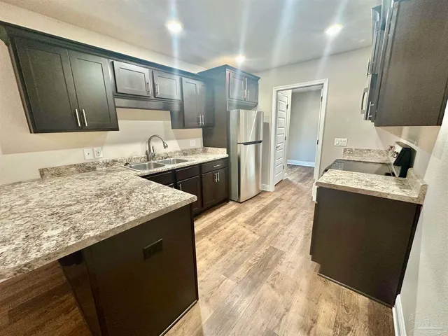 a kitchen with a sink stove and refrigerator