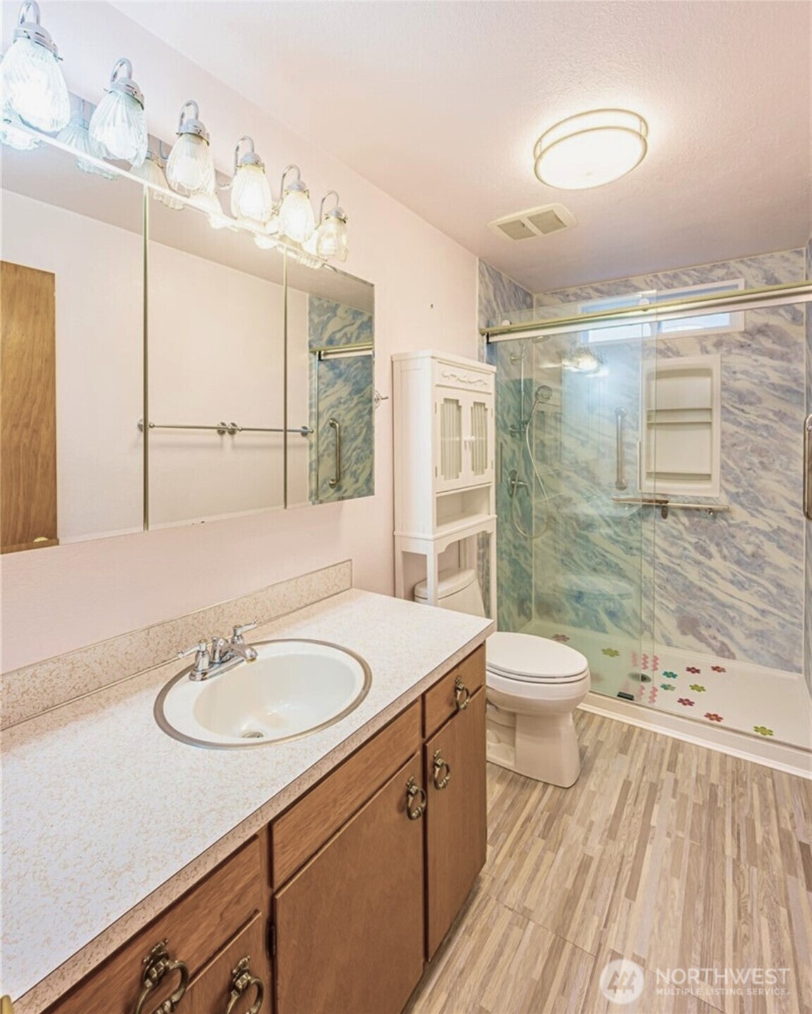 1030 11th Street Port Townsend, WA 98368 - Photo 11 of 21 a bathroom with a sink toilet a mirror and shower