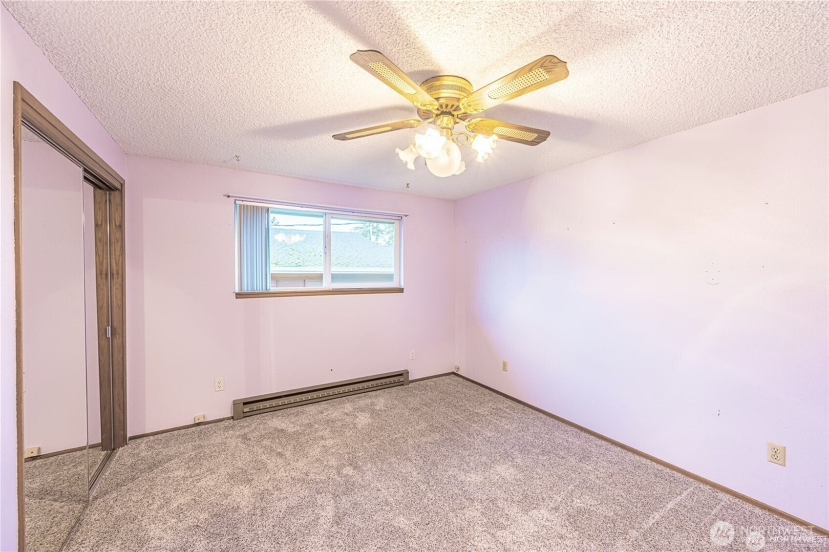 1030 11th Street Port Townsend, WA 98368 - Photo 12 of 21 an empty room with a window and chandelier fan