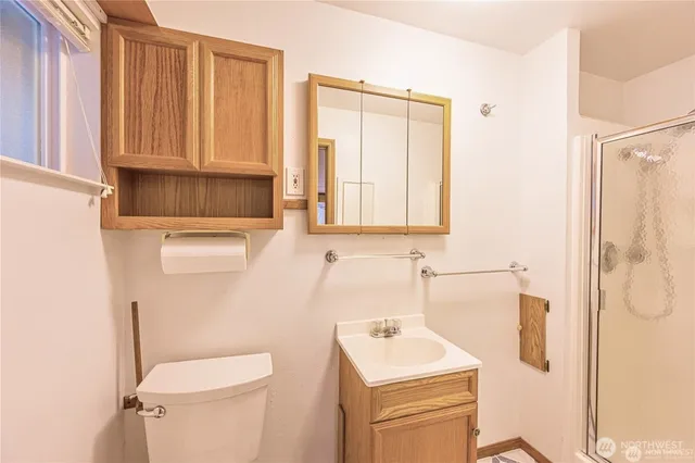 a bathroom with a sink a toilet and a mirror