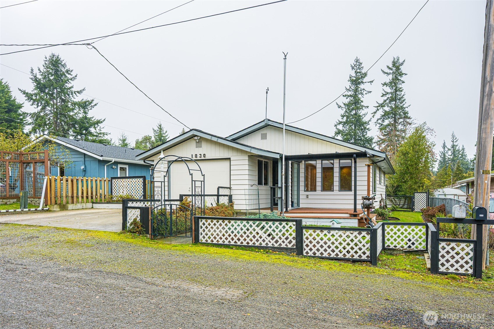 1030 11th Street Port Townsend, WA 98368 - Photo 2 of 21 a front view of a house with a yard and garage