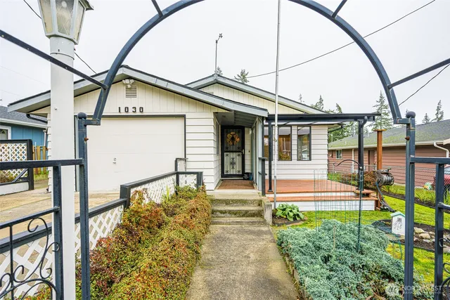 a front view of a house with a garden